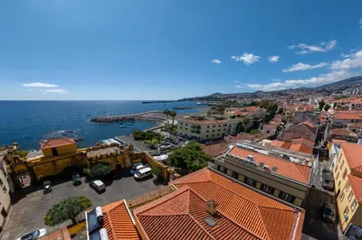an aerial view of a city and the ocean at OurMadeira - Fort of Old Town Apartments in Funchal