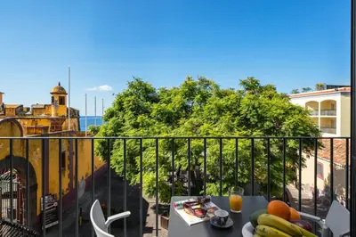 a balcony with a table with food on it at OurMadeira - Fort of Old Town Apartments in Funchal