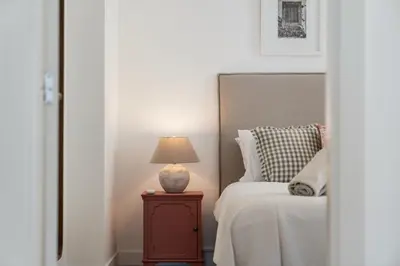 a bedroom with a bed and a lamp on a nightstand at OurMadeira - Fort of Old Town Apartments in Funchal