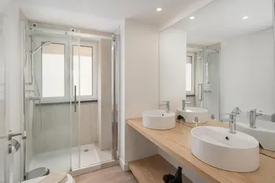 a bathroom with two sinks and a shower at OurMadeira - Fort of Old Town Apartments in Funchal