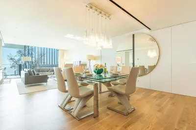 a dining room and living room with a table and chairs at Monumental Sea&Sky by Atlantic Holiday in Funchal
