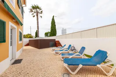 a row of blue chairs sitting on a patio at Western Mos Guesthouse in Lagos