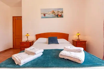 a bedroom with a bed with towels on it at Western Mos Guesthouse in Lagos