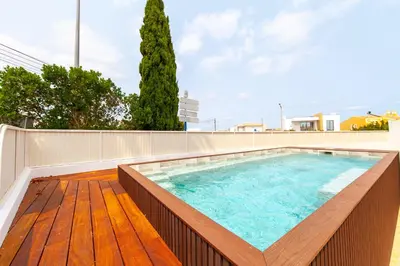 a large swimming pool on a wooden deck at Western Mos Guesthouse in Lagos