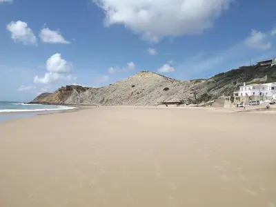 a sandy beach with a mountain in the background at Sea Studio Apartment in Budens