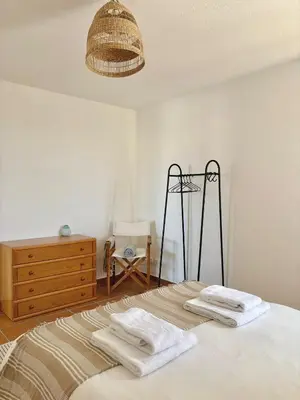 a bedroom with a bed with two towels on it at Casa Sul in Sagres