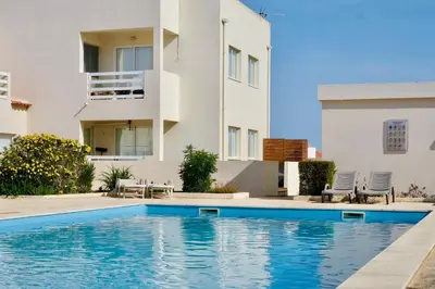 a house with a swimming pool in front of a building at Casa Sul in Sagres