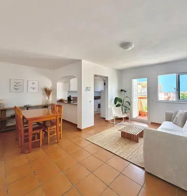 a kitchen and living room with a table and a couch at Casa Sul in Sagres