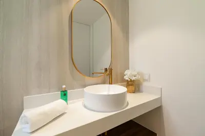 a bathroom with a white sink and a mirror at Villa das Neves in Estreito da Calheta