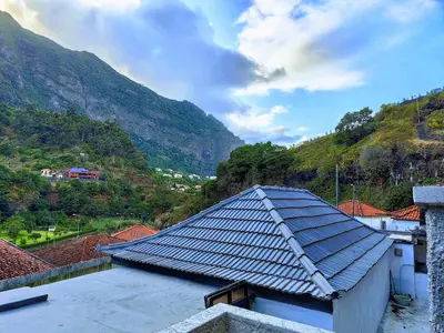 a view of a house with a slate roof at Casa das Grutas in São Vicente