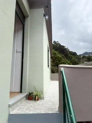 an open door to a balcony with a plant at Casa das Grutas in São Vicente