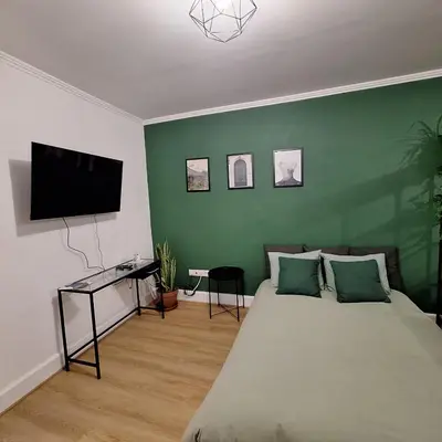 a bedroom with a bed and a flat screen tv at Casa das Grutas in São Vicente