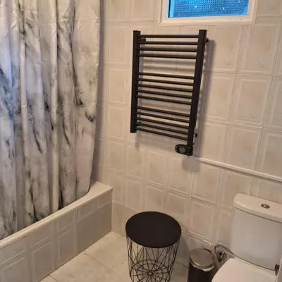 a bathroom with a toilet and a shower curtain at Casa das Grutas in São Vicente