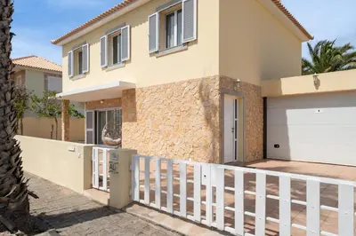 a house with a white fence in front of it at Moradia Felicidade Rocha PXO by An Island Apart in Porto Santo
