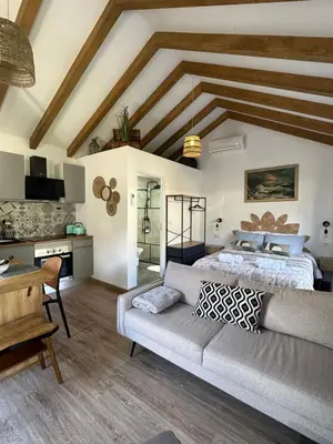 a living room with a couch and a kitchen at The Green Valley House II in São Vicente