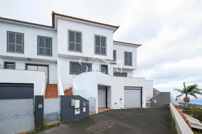 a white house with a lot of garage at Casa Pereira by SALIM in Santa Cruz