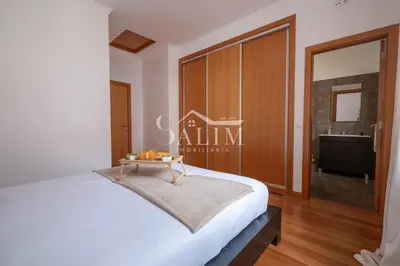 a bedroom with a bed with blue and white pillows at Casa Pereira by SALIM in Santa Cruz
