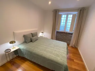 a bedroom with a large bed and a window at Loft Surdo in Funchal