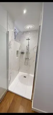 a bathroom with a shower with white marble walls at Loft Surdo in Funchal