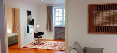 a living room with a couch and a window at Loft Surdo in Funchal