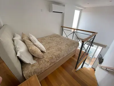 a bed with pillows on it in a room at Loft Surdo in Funchal