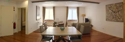a living room with a wooden table and chairs at Loft Surdo in Funchal