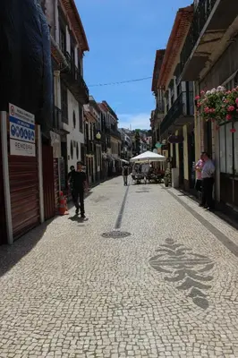 a man riding a skateboard down a cobblestone street at Loft Surdo in Funchal