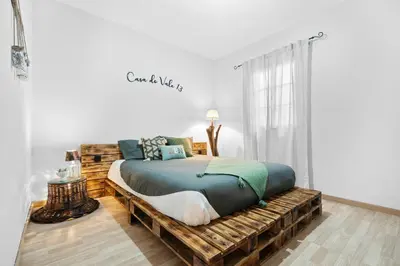 a bedroom with a bed made out of logs at Casa do Vale 13 - Ribeiro Frio in São Roque