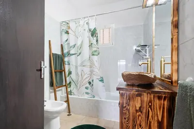 a bathroom with a toilet and a shower curtain at Casa do Vale 13 - Ribeiro Frio in São Roque