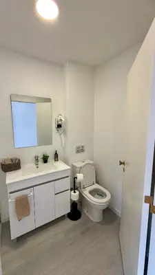 a bathroom with a toilet and a sink and a mirror at Nazaré Stay in Funchal