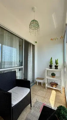 a living room with a couch and a chandelier at Nazaré Stay in Funchal