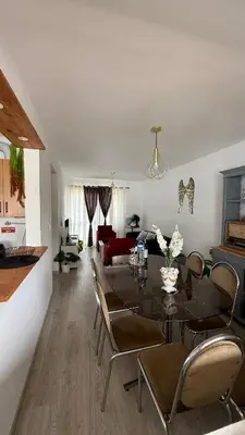 a dining room and living room with a table and chairs at Nazaré Stay in Funchal