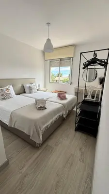 a bedroom with a large bed and a staircase at Nazaré Stay in Funchal