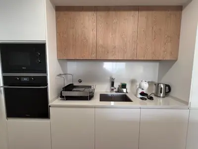a kitchen with a sink and a microwave at Saraiva Hills Ocean View Penthouse in Câmara de Lobos