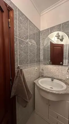 a bathroom with a sink and a mirror at Sea View Retreat in Caniço