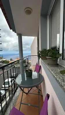 a table and chairs on a balcony with a view at Sea View Retreat in Caniço