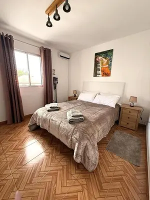 a bedroom with a large bed and a wooden floor at Picturesque stay Porto da Cruz in Porto da Cruz