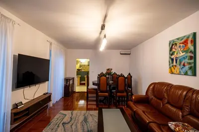 a living room with a couch and a television at Picturesque stay Porto da Cruz in Porto da Cruz
