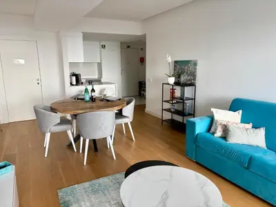 a living room with a blue couch and a table at Dream Home - everything you deserve! in Funchal