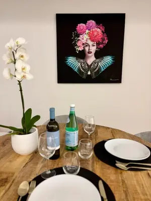 a wooden table with a plate and wine glasses at Dream Home - everything you deserve! in Funchal