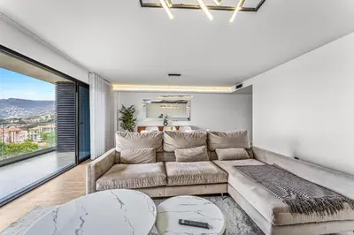 a living room with a couch and a large window at Sao Lucas Apartment Top Location in Funchal