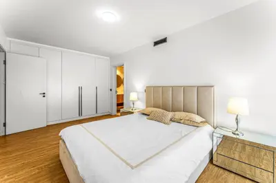 a white bedroom with a large bed and white cabinets at Sao Lucas Apartment Top Location in Funchal