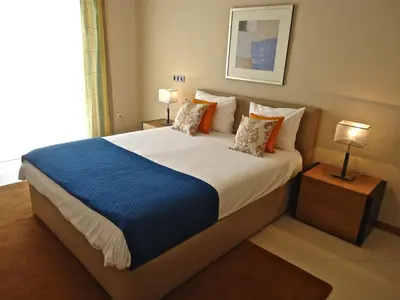 a large bed in a hotel room with two lamps at Golden Villa - Luxurious Beach Villa in Porto Santo