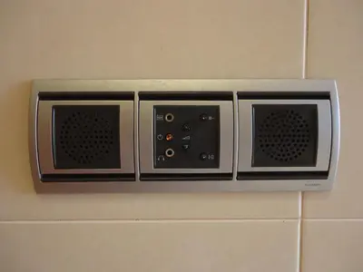 a wall mounted microwave with four controls on a wall at Golden Villa - Luxurious Beach Villa in Porto Santo