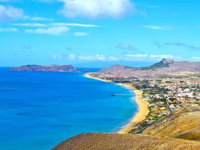a view of a beach with a city and the ocean at Golden Villa - Luxurious Beach Villa in Porto Santo