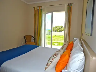 a bedroom with a bed with a view of the ocean at Golden Villa - Luxurious Beach Villa in Porto Santo