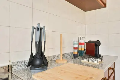 a kitchen counter with utensils on a counter top at Vila Vitalia in Machico