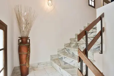 a staircase in a house with a vase at Vila Vitalia in Machico