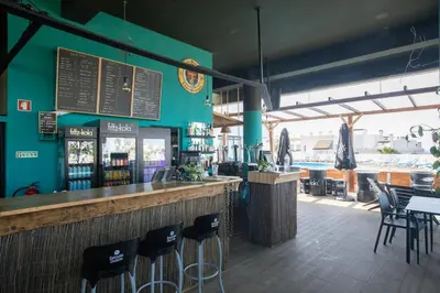 a bar in a seafood restaurant with tables and chairs at Beach View Lagos in Lagos