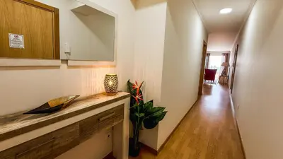 a bathroom with a sink and a toilet and a mirror at Refúgio na Quinta Girassol in Caniço
